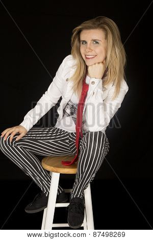 Female Model Sitting On Stool Wearing Striped Pants Smiling
