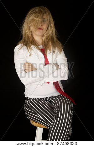 Blond Woman With Her Hair In Her Face Sitting On A Bar Stool