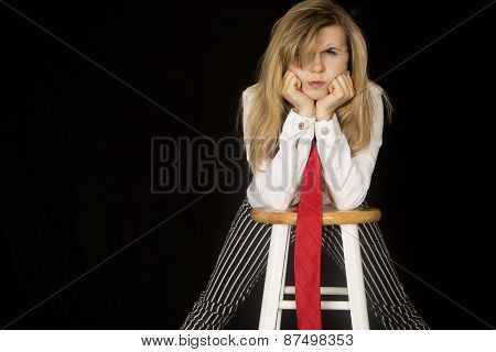 Angry Expression On Female Leaning On Elbows On A Barstool