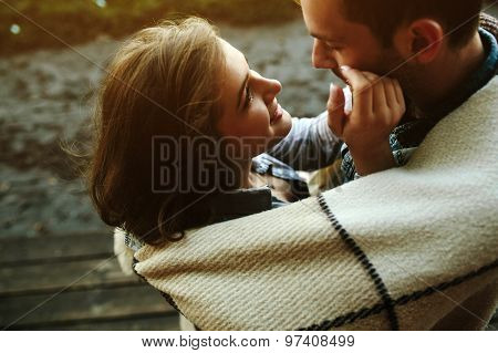 Young couple wrapped in plaid