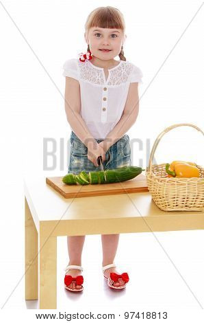 The girl cut vegetables