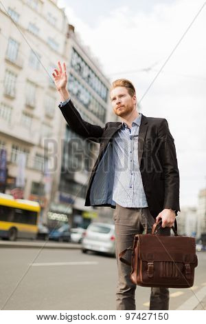 Budinessman Waving For Taxi