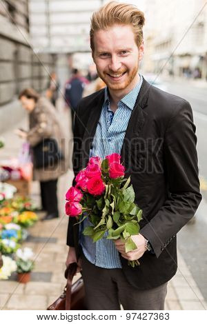 Businessman Holding Flowers And Smiling