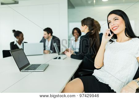 Beautiful Young Businesswoman Smiling And Happily Talking During Business Brainstorming