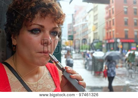 Young woman with electronic cigarette