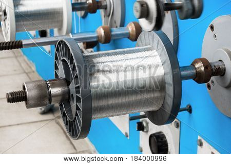 Coils with tinned wire. The spools are wound on an automatic winding machine.