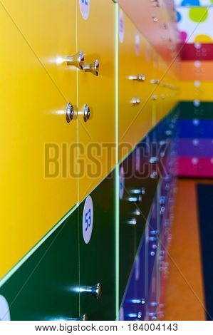 The wall is decorated with multi-colored storage chambers. A variant of the interior for children's rooms shops gambling halls. Numbered cell storage in a baggage room