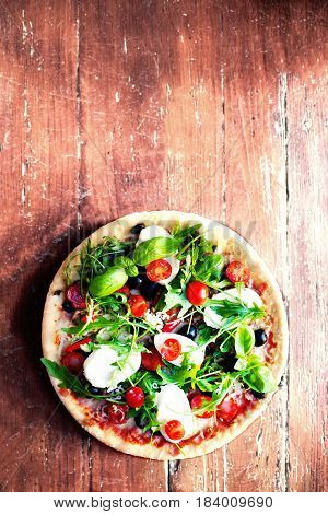 Delicious italian pizzas served on wooden table. Top view Pizza margherita on black table.