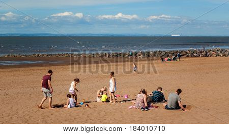 Minehead UK - July 27 2016: People walking and enjoying a summer day in a shoreside in Minehead UK.