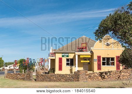 ASHTON SOUTH AFRICA - MARCH 26 2017: An antique shop with a display of suspended chairs in Ashton a town on the scenic Route 62 in the Western Cape Province