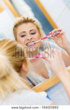 Woman Brushing Cleaning Teeth In Bathroom