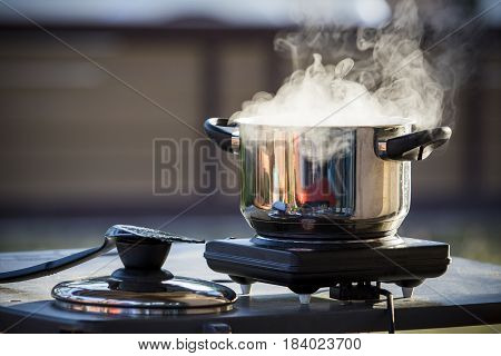 close up standless pot food cooking on electric stove