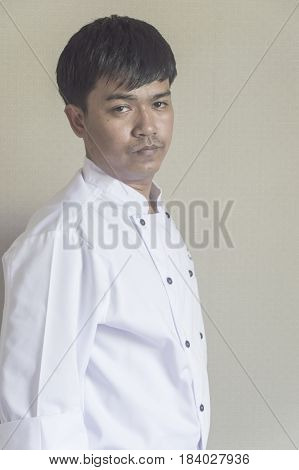 Chef portrait Asian young chef crossing arms.