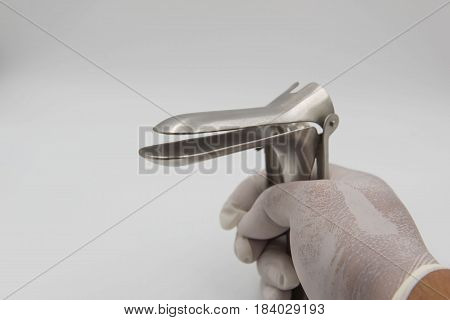 speculum in  hand doctor on white background.Medical concept .