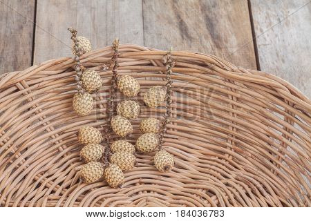 Closeup rattan fruit in wicker basket on wooden background