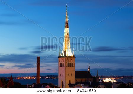 The spire of the Oleviste church against the background of the twilight sky. Old Tallinn/ Estonia