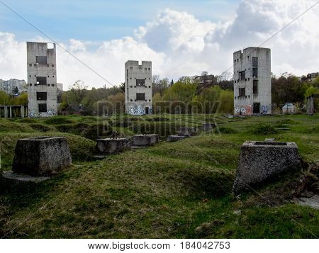 Three dilapidated sullen towers. Abandoned construction of three old tall buildings in the middle of the wasteland