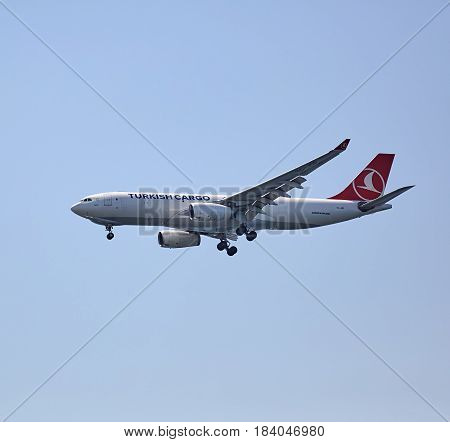 ISTANBUL TURKEY - JULY 11 2014: The cargo plan Airbus A330-220F of Turkish Airlines flying in the blue sky.