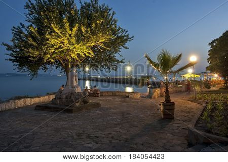 Pomorje Bulgaria - July 04.2012: Tourists on the path next to the beach on the sea coastin the evening