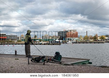 Saaremaa Estonia MAY 4 2014: A man near the lake are fishing.