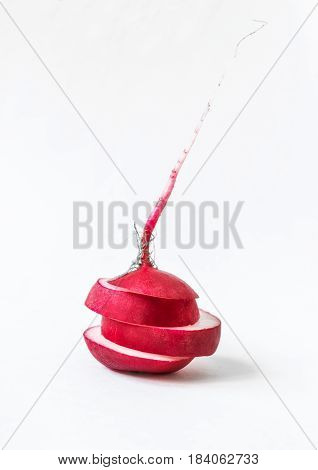 Sliced raw single radish on a white background