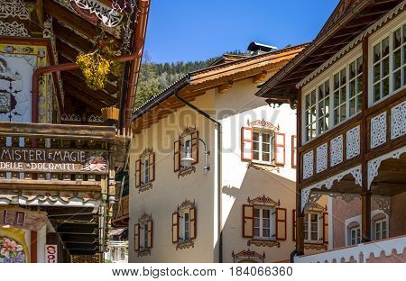 Canazei Italy - April 26 2012: Traditional fully decorated houses in the old village
