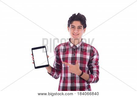 Smiliy frindly teenage boy holding the tablet and pointing to it teenager wearing red shirt isolated white background