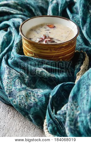 Traditional Indian Masala Tea In Ceramic Cup With Spices To Milk