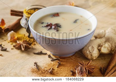 Traditional Indian Masala Tea In Ceramic Cup With Spices To Milk