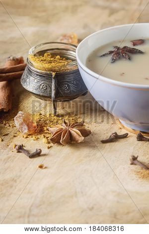 Traditional Indian Masala Tea In Ceramic Cup With Spices To Milk