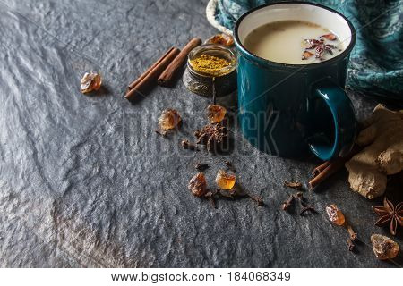 Traditional Indian Masala Tea In Ceramic Cup With Spices To Milk