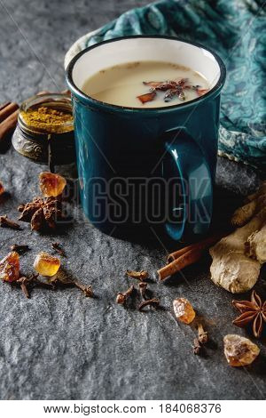 Traditional Indian Masala Tea In Ceramic Cup With Spices To Milk