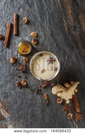 Traditional Indian Masala Tea In Ceramic Cup With Spices To Milk