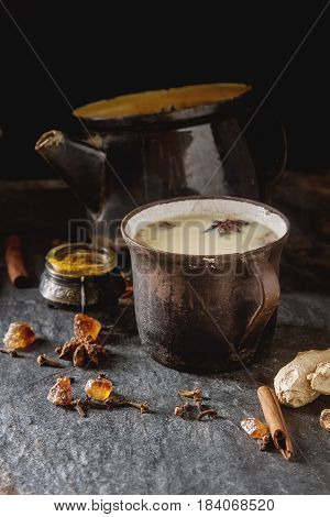 Traditional Indian Masala Tea In Ceramic Cup With Spices To Milk