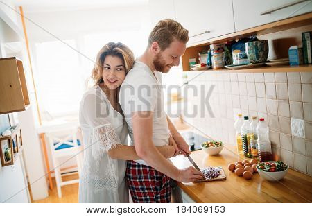 Romantic couple in love speding time together in kitchen