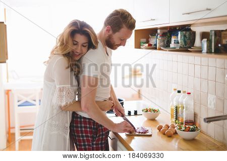 Romantic couple in love speding time together in kitchen