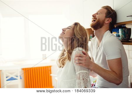 Romantic couple in love speding time together in kitchen