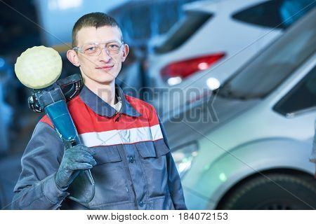 auto mechanic with buffing machine