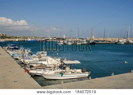Zygi fishing village harbour with fishing boats moored in Spring
