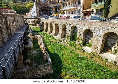 An old quarter with sulfur baths in Tbilisi a view of the shrunken canal. April 17 2015