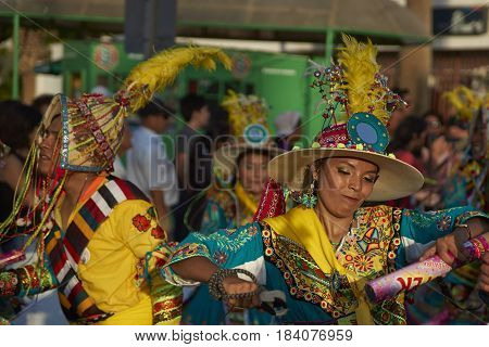 ARICA, CHILE - FEBRUARY 11, 2017: Tinkus Dance Group dressed in ornate costumes performing a traditional dance during a street parade at the annual Carnaval Andino con la Fuerza del Sol.