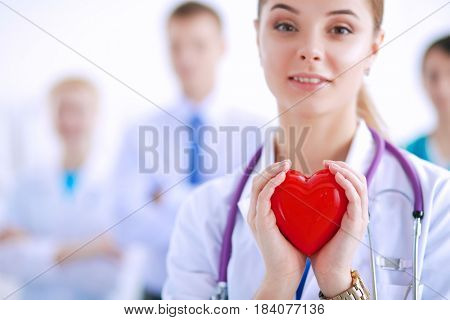 Female doctor with stethoscope holding red heart