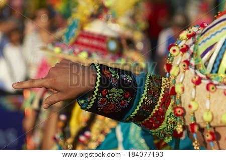 ARICA, CHILE - FEBRUARY 11, 2017: Tinkus Dance Group dressed in ornate costumes performing a traditional dance during a street parade at the annual Carnaval Andino con la Fuerza del Sol.
