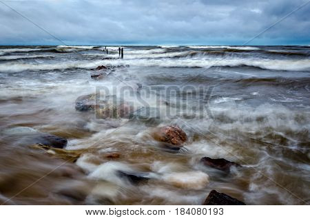 During the storm the old pier is under water.