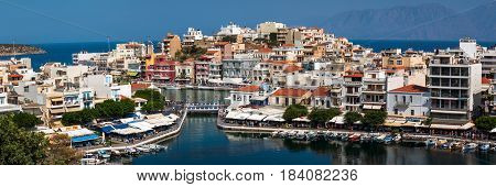 AGHIOS NIKOLAOS, CRETE, GREECE - APRIL 2017: Architecture of a small harbor at Aghios Nikolaos town on Crete island, Greece