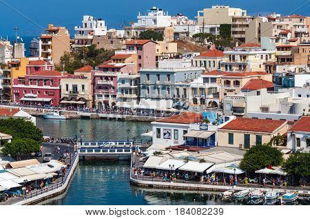 AGHIOS NIKOLAOS, CRETE, GREECE - AUGUST 2016: Small harbor with moored fishing boats at Aghios Nikolaos town on Crete island, Greece