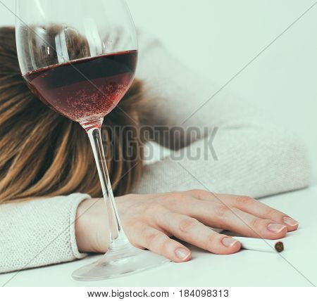 Drunk Woman Sleeping On The Table. Female Alcoholism.