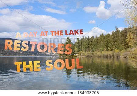 Conceptual inspiring image with scenic lake landscape. Calm water and reflections on water. Colorful text: A day at the lake restores the soul.