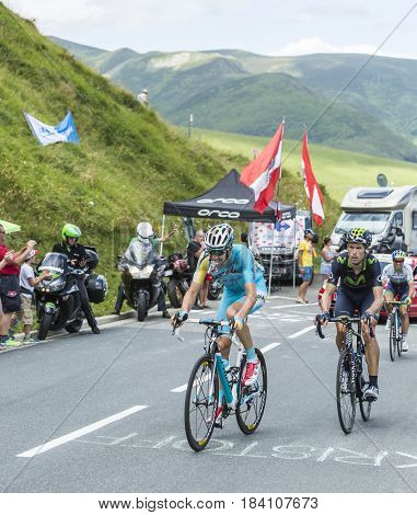 Col de PeyresourdeFrance- July 23 2014: Two cyclists Alessandro Vanotti of Astana Team and Imanol Erviti Ollo of Movistar Team climbing the road to Col de Peyresourde in Pyrenees Mountains during the stage 17 of Le Tour de France on 23 July 2014.
