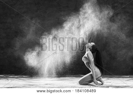 Black and white portrait of young dancer with white flour